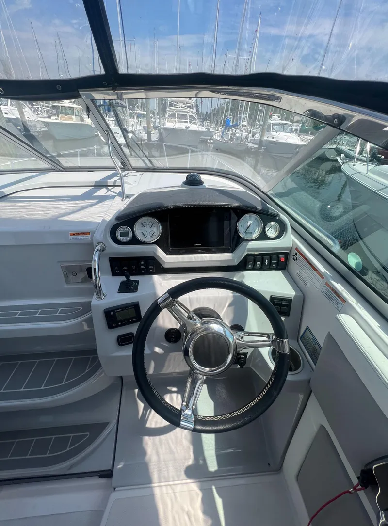 Slide: The Image of 2019 Regal 28 Express boat cockpit with steering wheel and dashboard. - 30