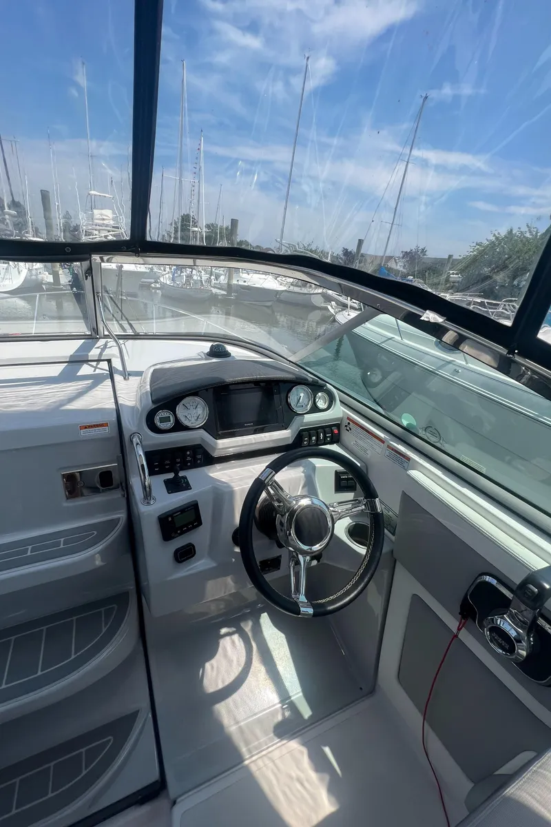 Slide: The Image of 2019 Regal 28 Express boat cockpit with steering wheel and dashboard. - 31