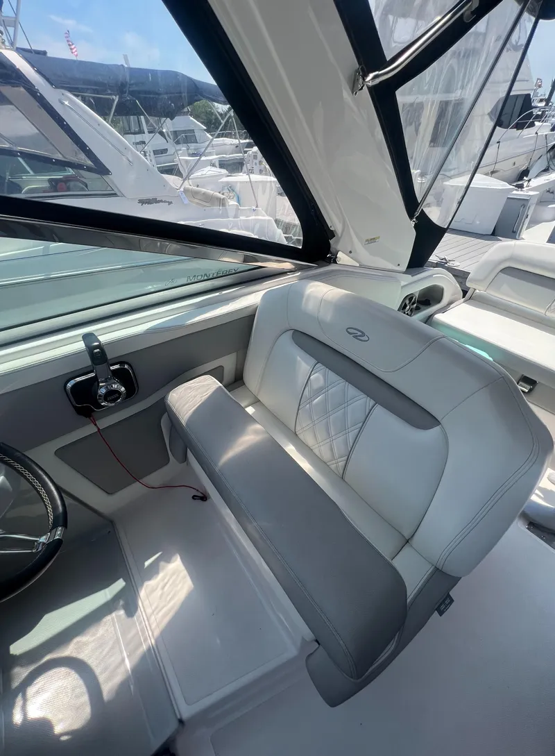 Slide: The Image of 2019 Regal 28 Express boat interior with helm seat and steering wheel. - 32