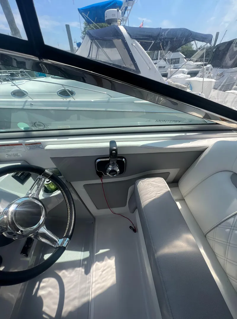 Slide: The Image of 2019 Regal 28 Express boat cockpit with steering wheel and seating. - 33