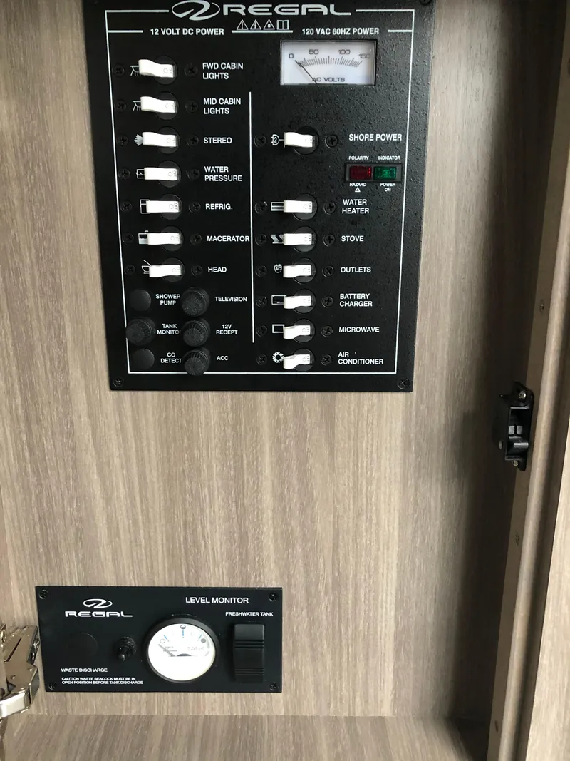 Slide: The Image of 2019 Regal 28 Express control panel and level monitor. - 39