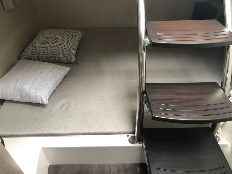 Slide: The Image of 2019 Regal 28 Express cabin interior with bed and wooden steps. - 41