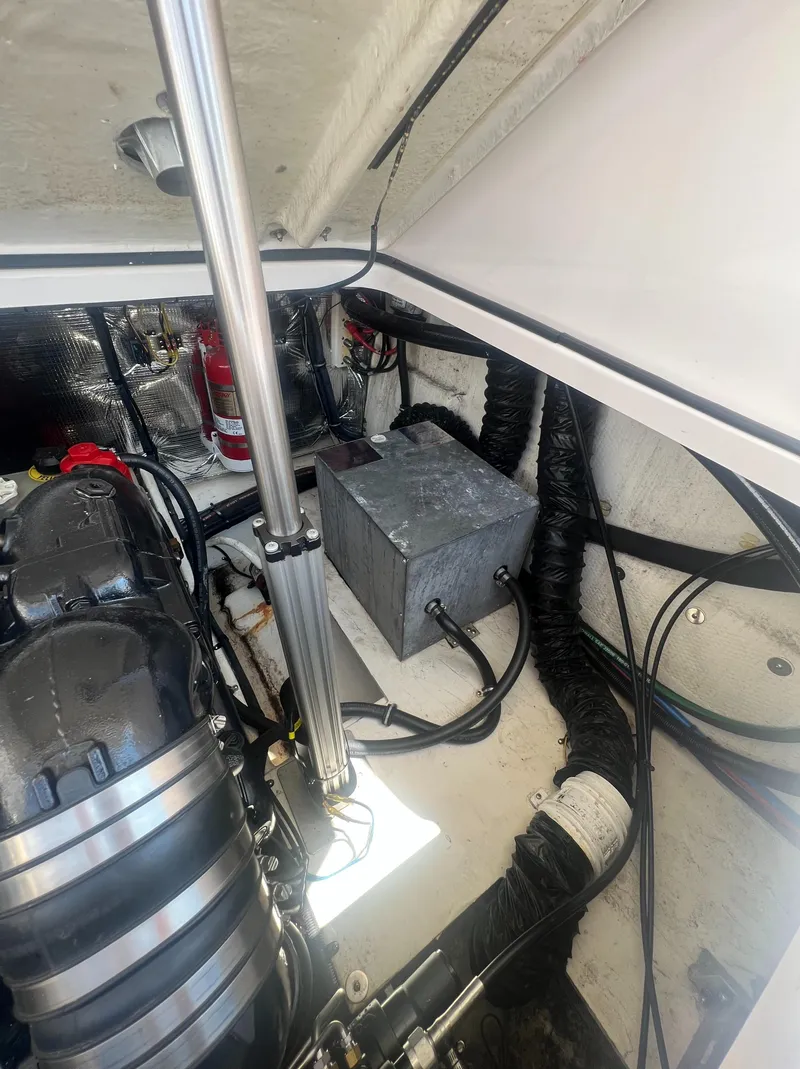 Slide: The Image of Engine compartment of a 2019 Regal 28 Express boat showing mechanical components. - 45