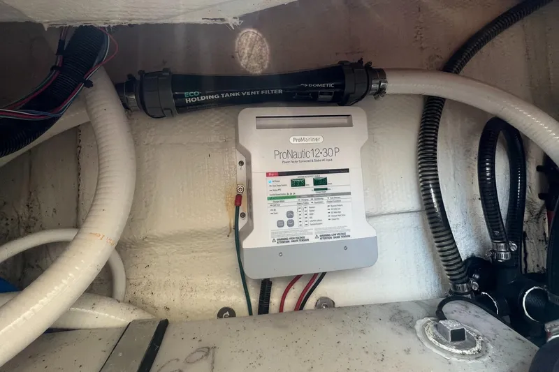 Slide: The Image of 2019 Regal 28 Express boat interior with ProNautic 12-30P charger and holding tank vent filter. - 46
