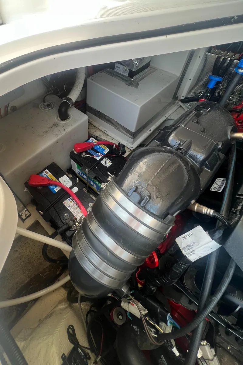 Slide: The Image of 2019 Regal 28 Express engine compartment with batteries and wiring. - 48