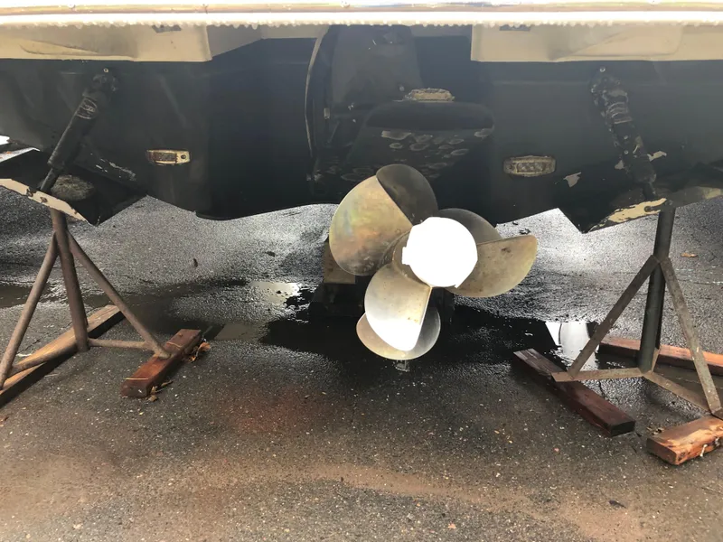 Slide: The Image of 2019 Regal 28 Express boat propeller and stern on stands. - 49