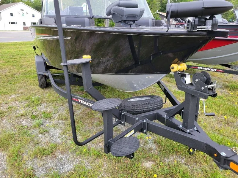 Slide: The Image of 2024 Tracker Targa V19 Combo boat on trailer, parked on grass. - 12