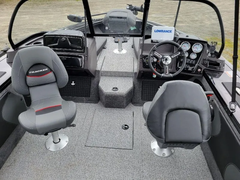 Slide: The Image of 2024 Tracker Targa V19 Combo boat interior with steering console and seating. - 7