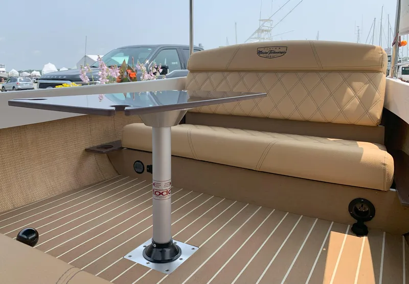 Slide: The Image of 2023 Vision Marine Technologies Quietude 156 boat interior with beige seating and table. - 5
