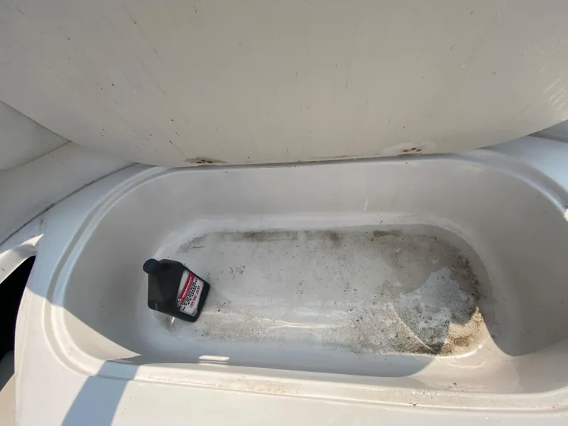 Slide: The Image of Storage compartment of a 2009 Starcraft 2410 OB Limited boat with a bottle inside. - 10