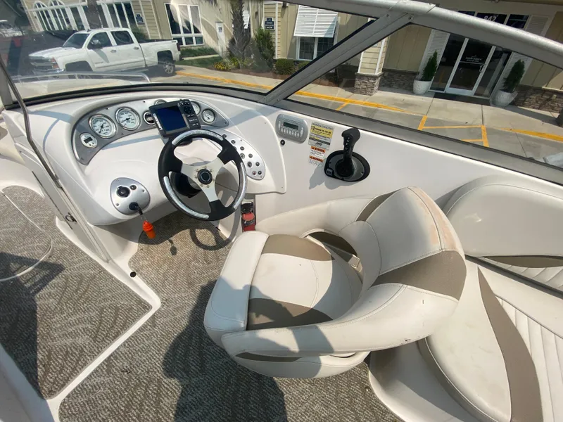 Slide: The Image of 2009 Starcraft 2410 OB Limited boat cockpit with steering wheel and control panel. - 11