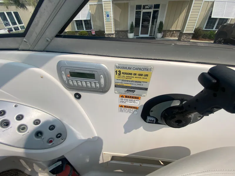 Slide: The Image of 2009 Starcraft 2410 OB Limited boat dashboard with capacity and warning labels. - 12