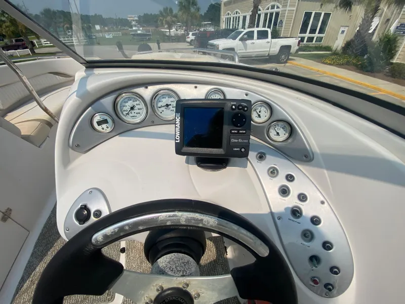 Slide: The Image of 2009 Starcraft 2410 OB Limited boat dashboard with gauges and Lowrance GPS. - 16