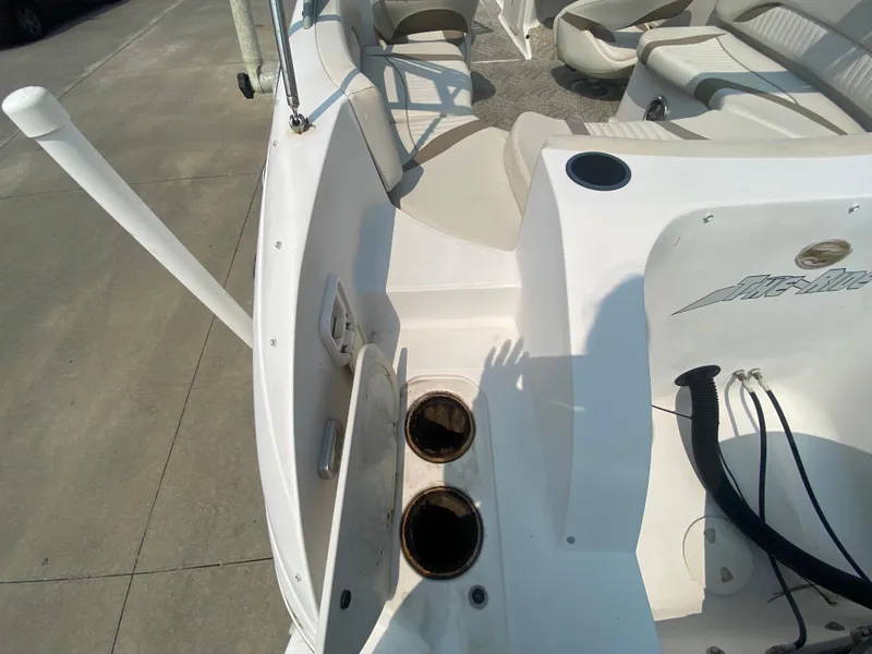 Slide: The Image of 2009 Starcraft 2410 OB Limited boat interior with cup holders and seating. - 5