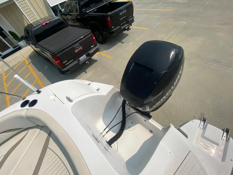 Slide: The Image of 2009 Starcraft 2410 OB Limited boat with Mercury outboard motor in parking lot. - 6