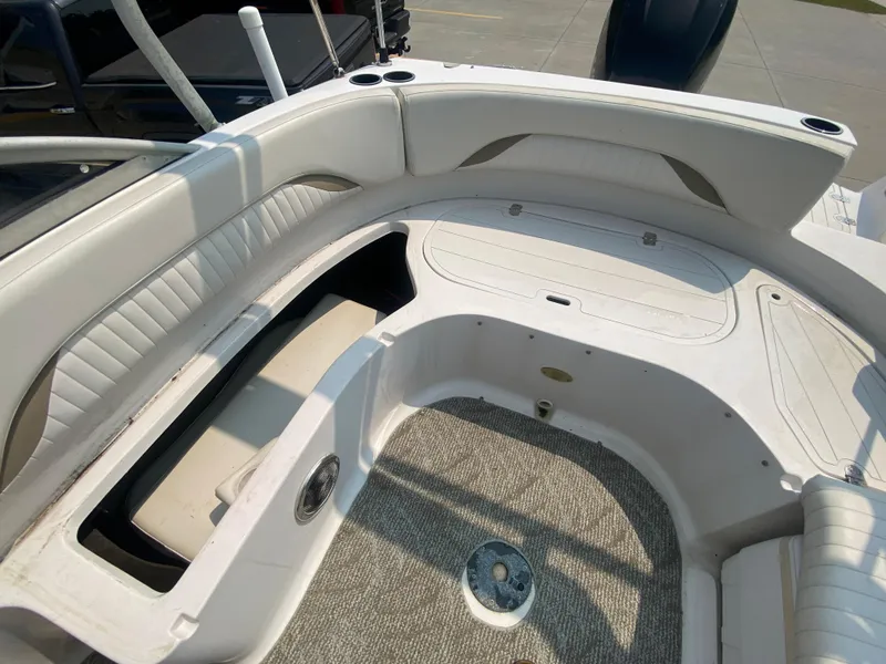 Slide: The Image of 2009 Starcraft 2410 OB Limited boat interior with white seating and carpeted floor. - 8