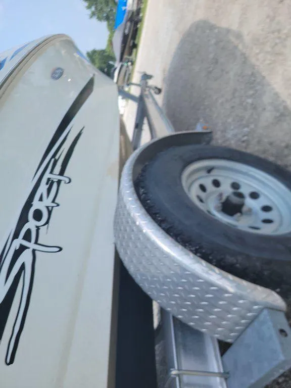 Slide: The Image of Close-up of a 2011 Sea Ray 195 Sport boat on a trailer. - 11