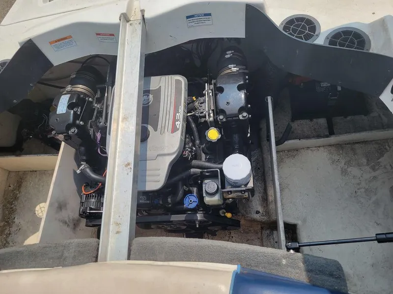 Slide: The Image of 2011 Sea Ray 195 Sport boat engine compartment with dual engines. - 12