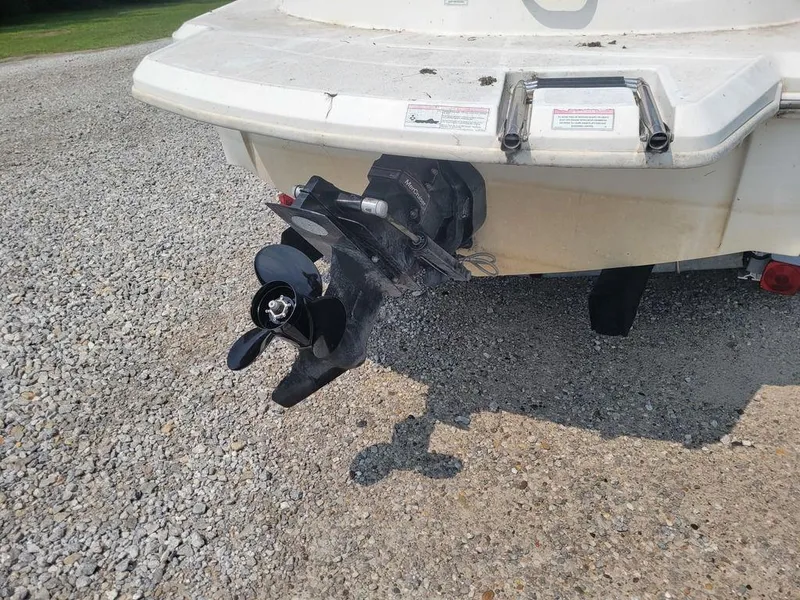 Slide: The Image of 2011 Sea Ray 195 Sport boat stern with propeller on gravel. - 14