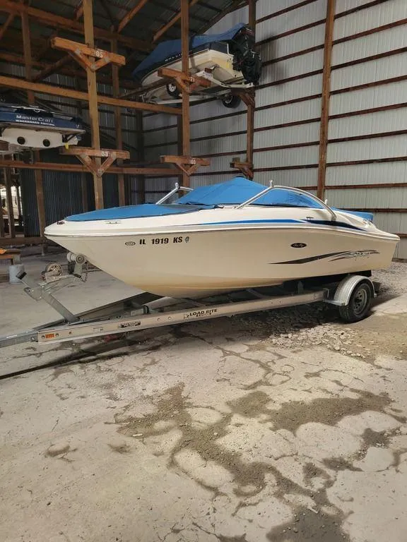 Slide: The Image of 2011 Sea Ray 195 Sport boat on trailer in storage facility. - 15