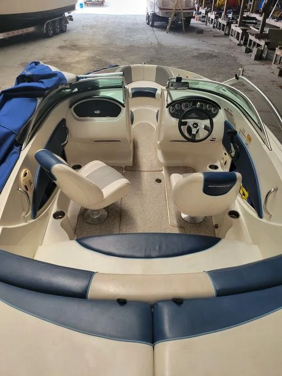 Slide: The Image of 2011 Sea Ray 195 Sport boat interior with blue and white seating. - 18