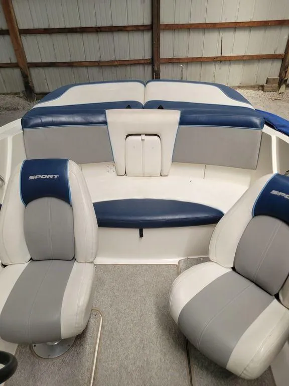 Slide: The Image of 2011 Sea Ray 195 Sport boat interior with blue and white seating. - 19