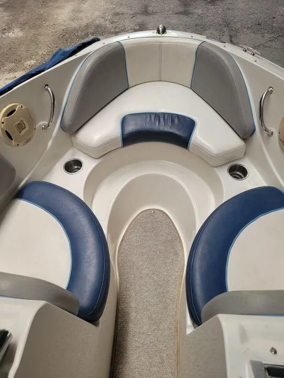 Slide: The Image of 2011 Sea Ray 195 Sport boat interior with blue and white seating. - 2