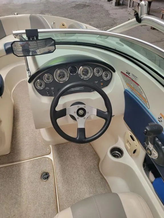 Slide: The Image of 2011 Sea Ray 195 Sport boat dashboard with steering wheel and instrument panel. - 21