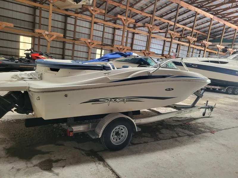 Slide: The Image of 2011 Sea Ray 195 Sport boat on trailer in storage facility. - 23