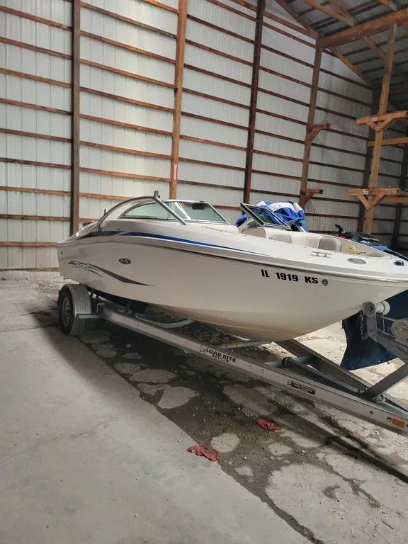 Slide: The Image of 2011 Sea Ray 195 Sport boat on trailer in storage facility. - 24