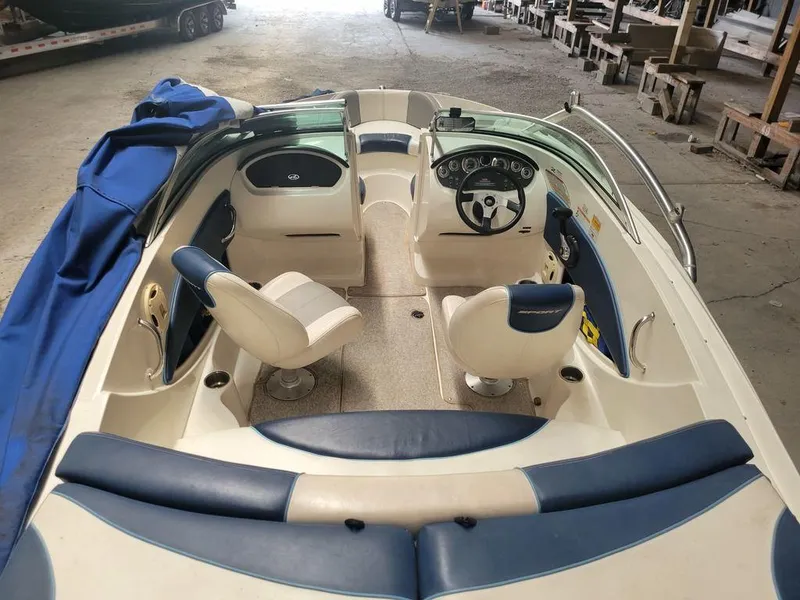 Slide: The Image of 2011 Sea Ray 195 Sport boat interior with blue and white seating. - 3