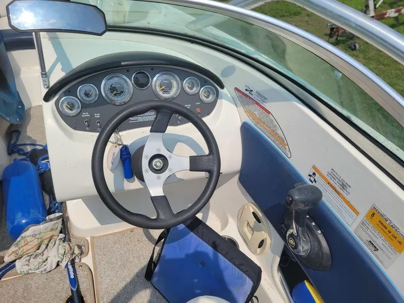 Slide: The Image of 2011 Sea Ray 195 Sport boat dashboard with steering wheel and control panel. - 4
