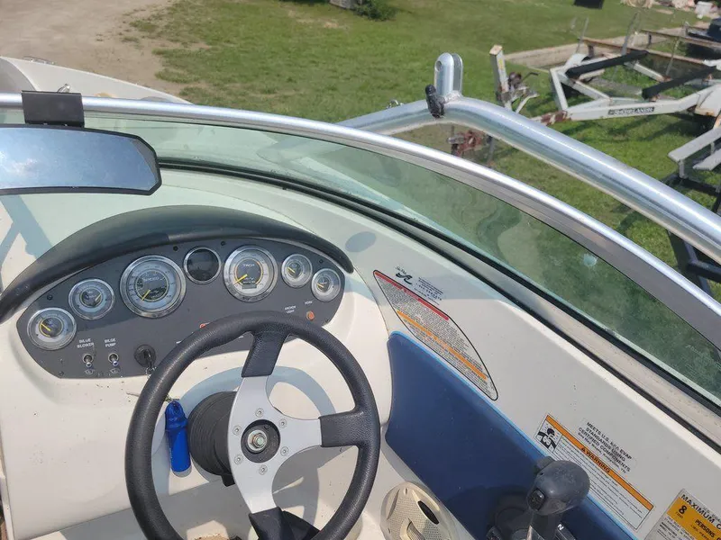 Slide: The Image of 2011 Sea Ray 195 Sport boat dashboard and steering wheel. - 6