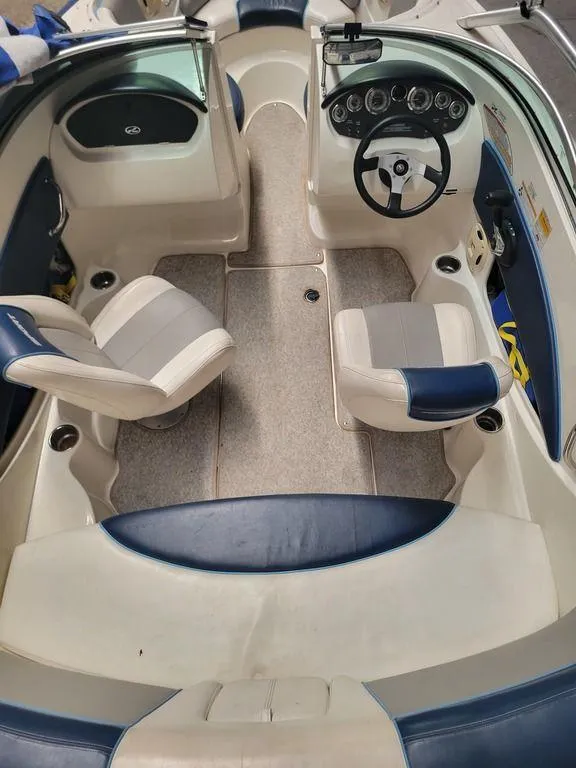 Slide: The Image of 2011 Sea Ray 195 Sport boat interior with dual seats and steering console. - 7