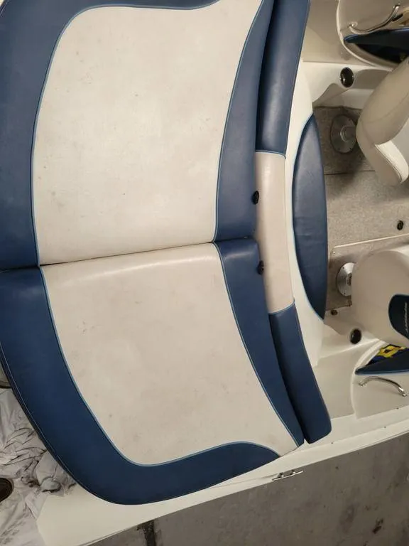 Slide: The Image of 2011 Sea Ray 195 Sport boat interior seating with blue and white upholstery. - 8