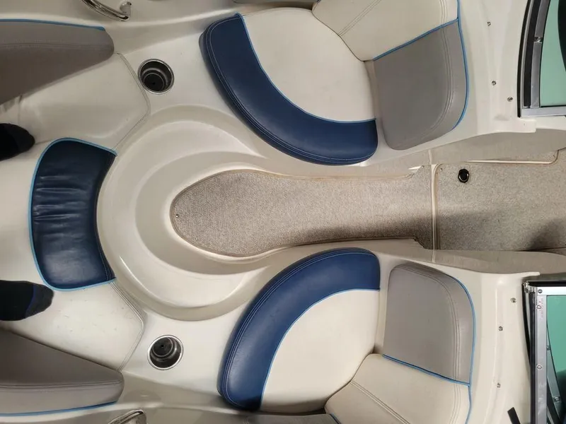 Slide: The Image of Interior seating of a 2011 Sea Ray 195 Sport boat with blue and white upholstery. - 9
