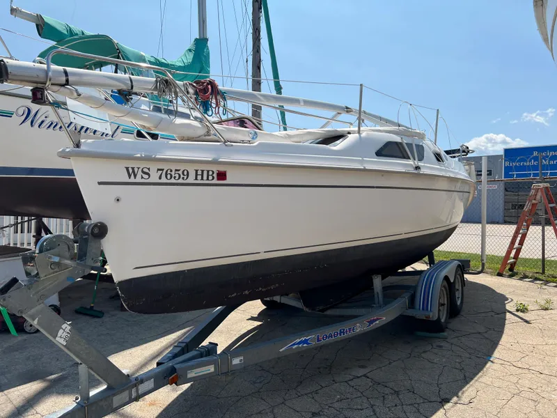 Slide: The Image of 2007 Hunter 25 sailboat on trailer in marina setting. - 10