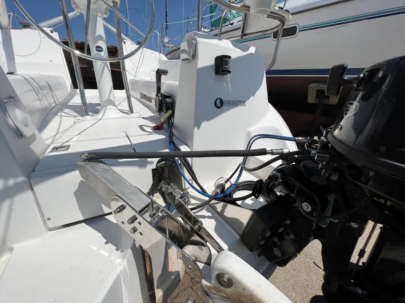 Slide: The Image of 2007 Hunter 25 sailboat cockpit with outboard motor and steering wheel. - 16