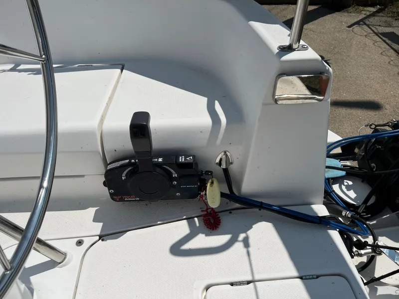 Slide: The Image of Cockpit controls of a 2007 Hunter 25 sailboat, featuring steering wheel and throttle lever. - 17