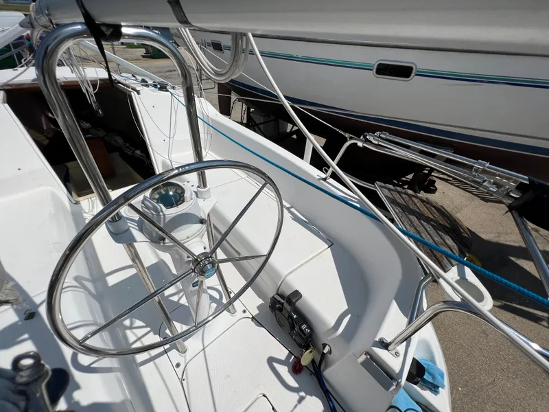 Slide: The Image of 2007 Hunter 25 sailboat cockpit with steering wheel and rigging details. - 18