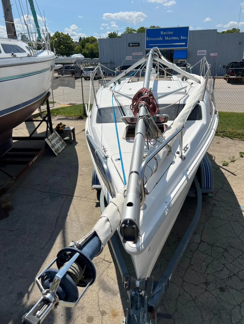 Slide: The Image of 2007 Hunter 25 sailboat on trailer at a marina. - 23