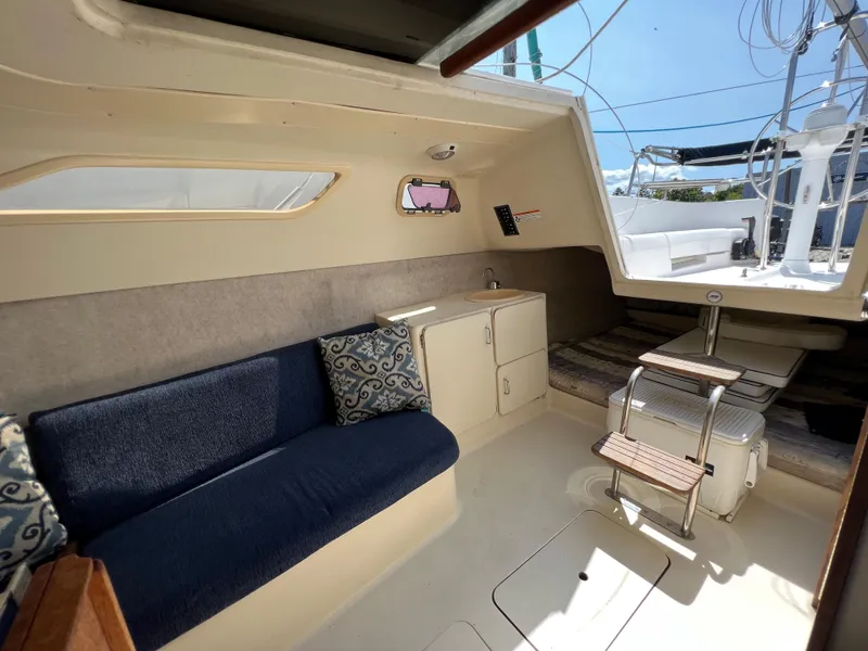 Slide: The Image of Interior of 2007 Hunter 25 sailboat with seating, table, and storage. - 33