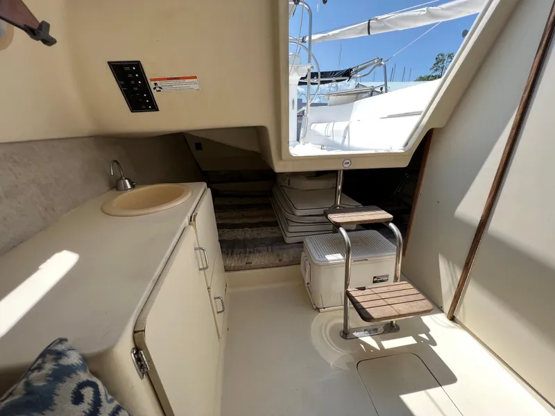 Slide: The Image of Interior of 2007 Hunter 25 sailboat with compact kitchenette and seating area. - 34