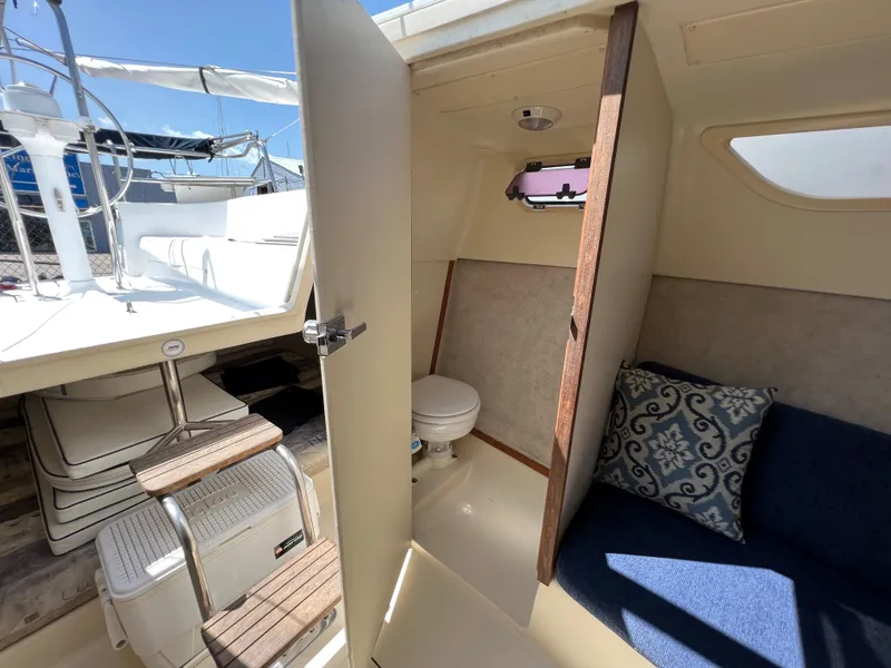 Slide: The Image of 2007 Hunter 25 sailboat interior with toilet, seating, and helm. - 36