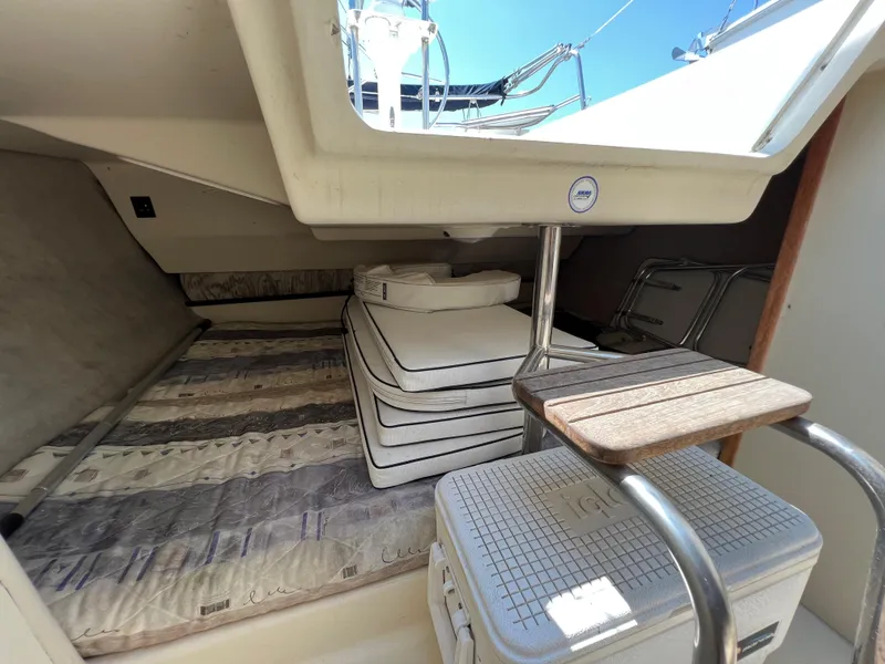 Slide: The Image of Interior cabin of 2007 Hunter 25 sailboat with stacked cushions and hatch. - 38