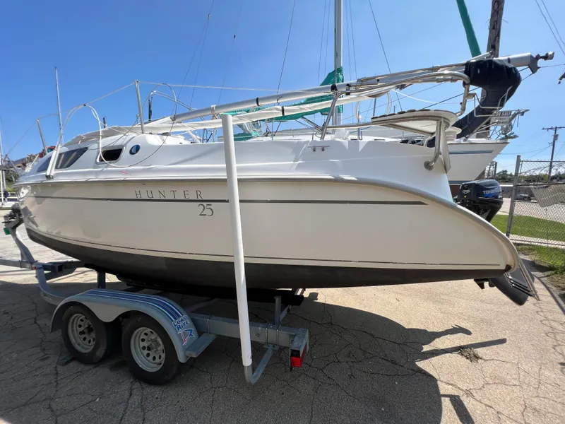 Slide: The Image of 2007 Hunter 25 sailboat on trailer, side view, sunny day. - 8