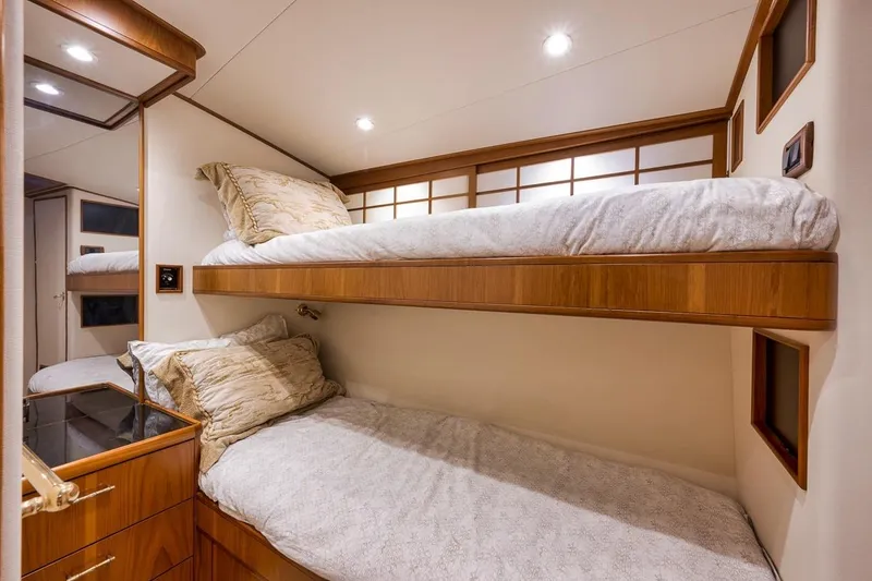 Slide: The Image of Interior of 2001 Rybovich Sportfisherman yacht with cozy bunk beds and wooden accents. - 10