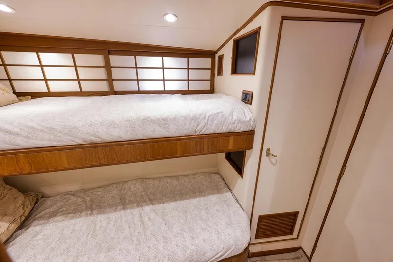 Slide: The Image of Interior of 2001 Rybovich Sportfisherman with cozy bunk beds and wooden accents. - 11