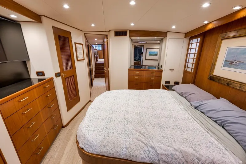 Slide: The Image of Luxurious 2001 Rybovich Sportfisherman yacht bedroom with elegant wood finishes and cozy bedding. - 17