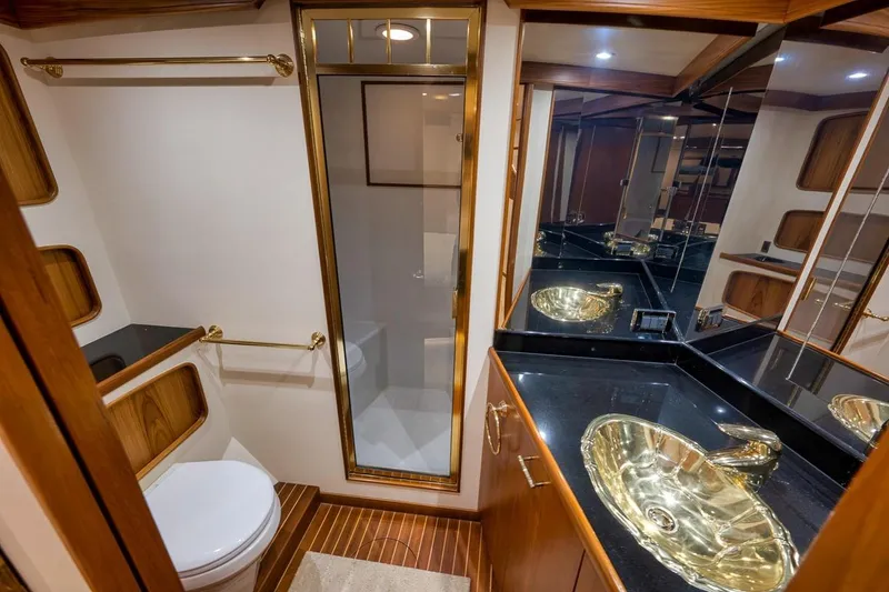 Slide: The Image of Luxurious bathroom in 2001 Rybovich Sportfisherman yacht with gold fixtures and wood accents. - 18